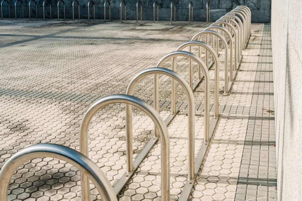 Bars to park bicycles, empty, installed at the entrance of a building.