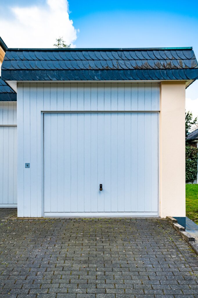wide garage door and concrete driveway in front